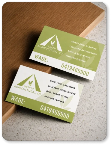 Inskip green and cream business cards on a timber desk.